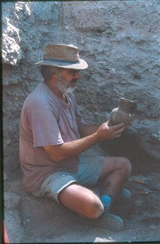 Dr. Downing with a pot he found on a dig.